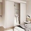 A white pleated fabric room divider curtain is shown in a modern bedroom setting.