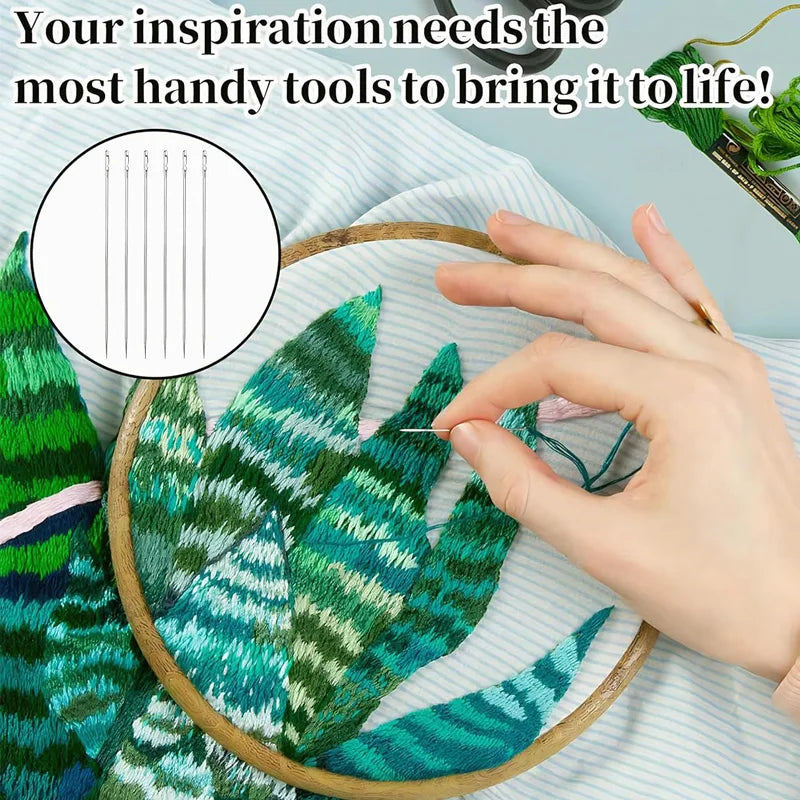 A hand holds a green fabric featuring tropical leaf patterns, with a precision sewing kit visible nearby.