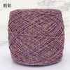 A ball of metallic silk crocheting and knitting yarn in shades of purple, pink, and gold.