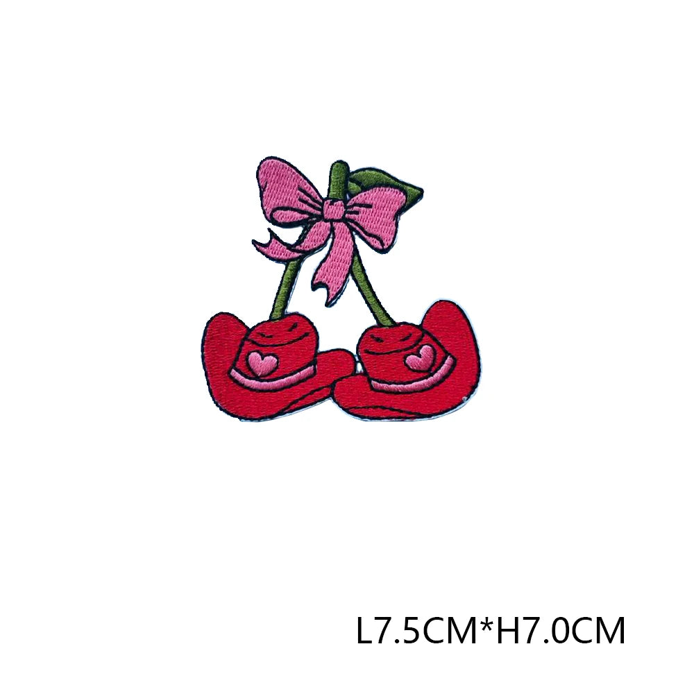Pink and red embroidered letter patches featuring a bow design.