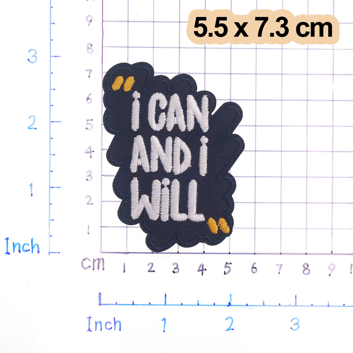 Black iron-on embroidered text patch with the phrase I CAN AND I WILL on a grid background.