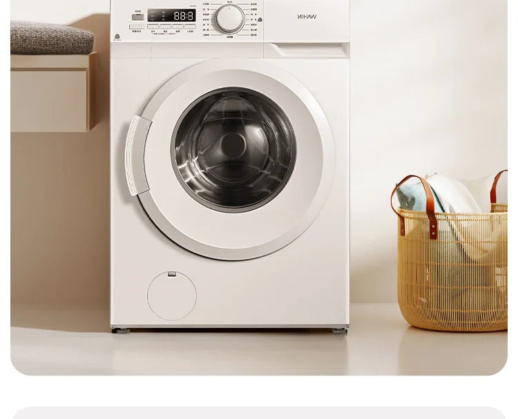 A white washing machine with a round door is shown on a light surface.