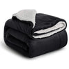A black sherpa fleece blanket with white trim is folded and displayed.