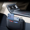 A black universal car organizer storage bag holding several smartphones in a car interior slot.
