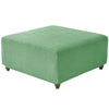 A square ottoman covered in a textured, sage green stretch jacquard fabric.