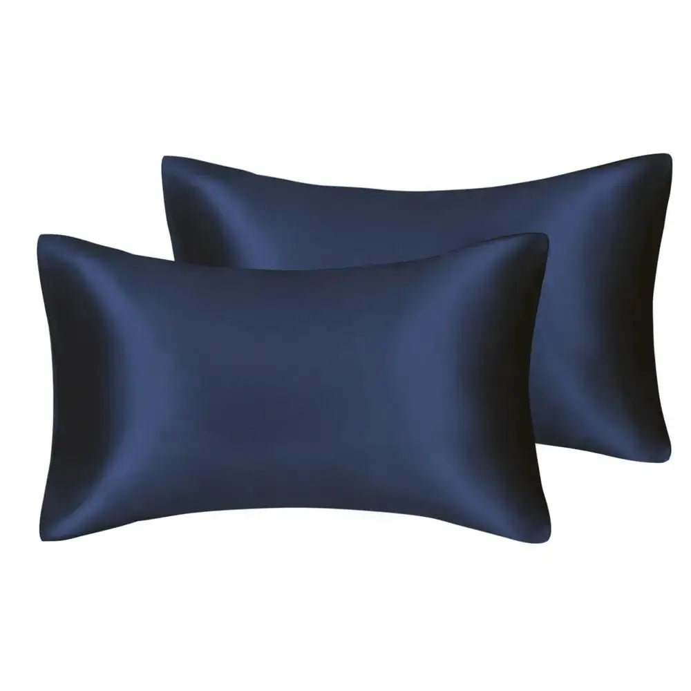 A pair of dark navy blue silky satin pillow covers, likely for a queen size pillow.