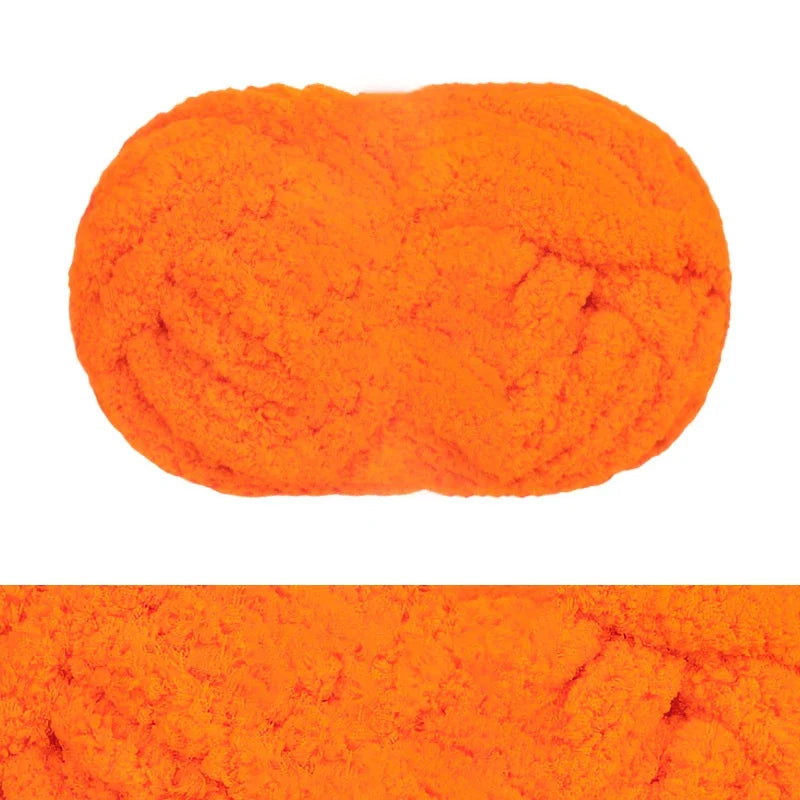 A bright orange hand-knitted wool finger line scarf displayed as a textured, oval object.