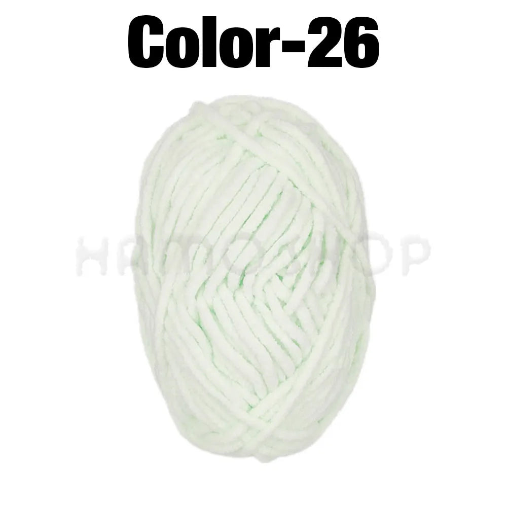 A ball of white or light green chenille yarn labeled Color-26 for crafting.