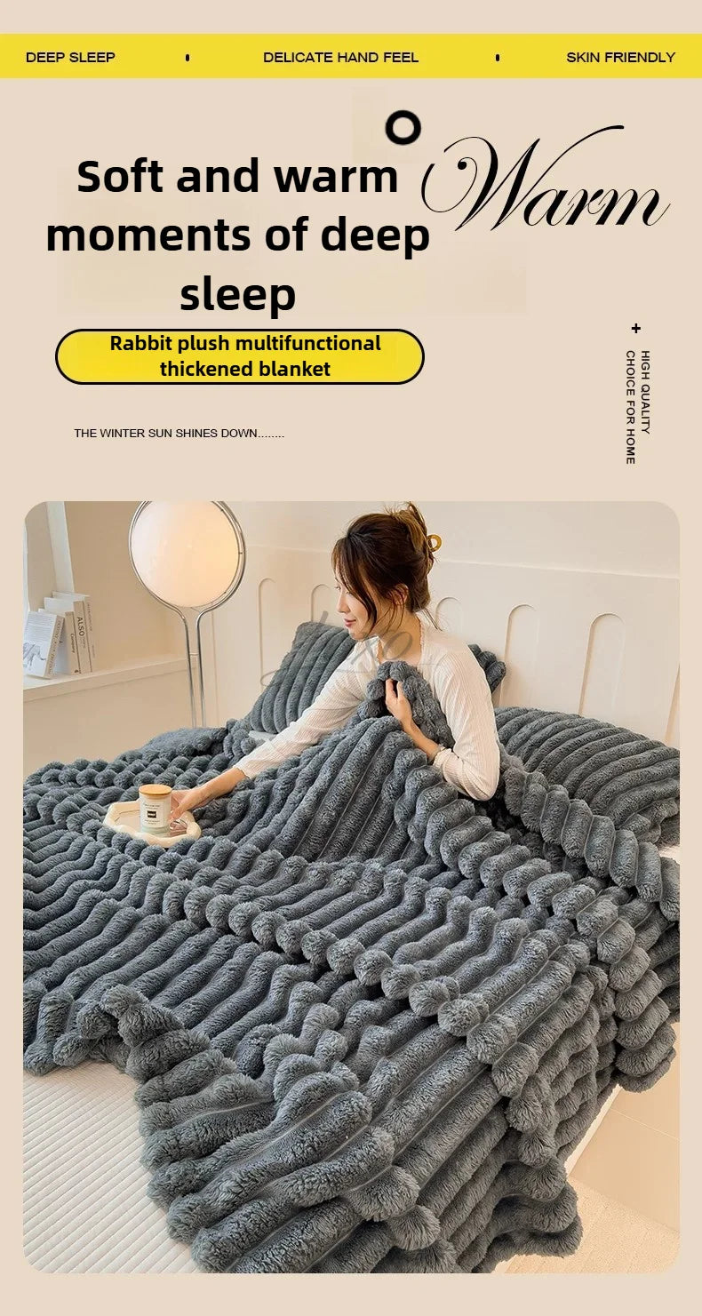 A gray rabbit plush multifunctional thickened blanket draped over a bed, showing its soft texture.