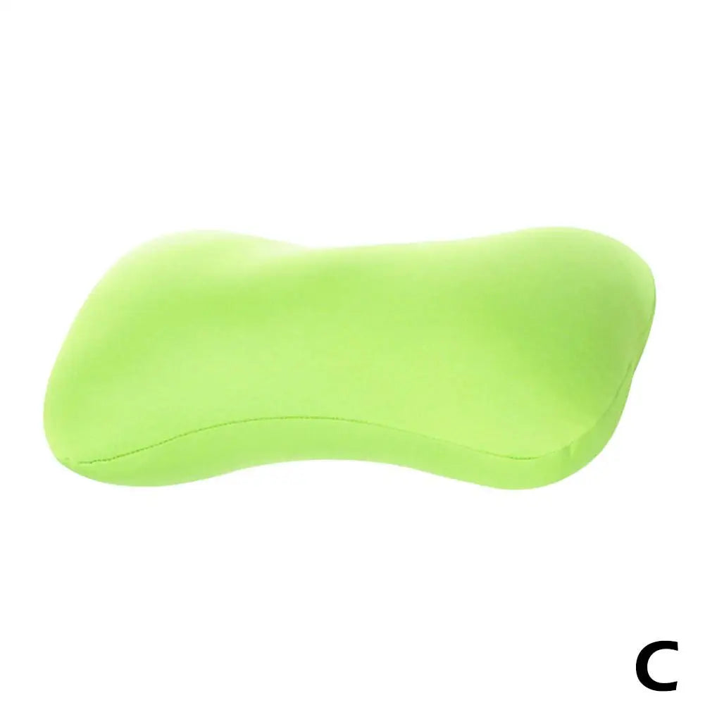 A lime green microbead neck pillow shown from the side.