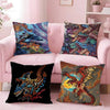 A set of four pillows featuring anime style monster prints on a pink sofa.