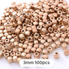 A pile of small, round, gold-colored geometric acrylic beads for jewelry making