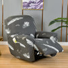 A gray recliner chair with a white feather print slipcover sitting on a wooden floor.