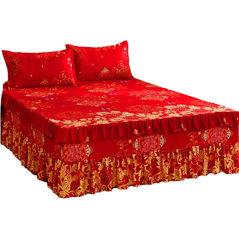 A set of three red fitted bed sheets with gold embroidery and elastic lace trim.