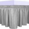 A silver ruffled bed skirt set with a gathered bottom edge.