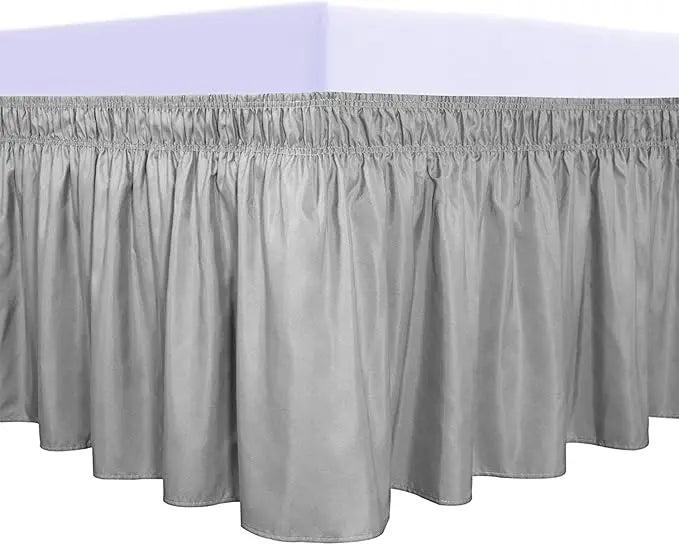 A silver ruffled bed skirt set with a gathered bottom edge.
