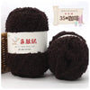 A dark brown ball of soft coral velvet yarn for crafting with a label showing the brand name and instructions.