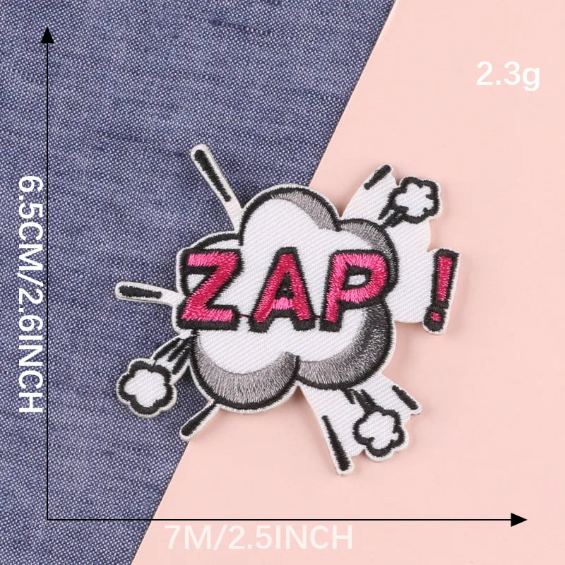 A white embroidery patch with black cloud design and pink lettering ZAP!