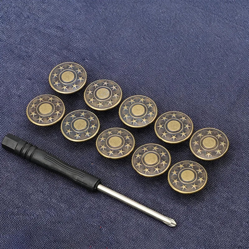 A set of adjustable metal snap buttons with a gold finish arranged on a dark blue fabric.