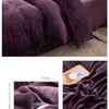 A luxurious purple flannel duvet cover set displayed on a bed, showing the texture and folds of the fabric.