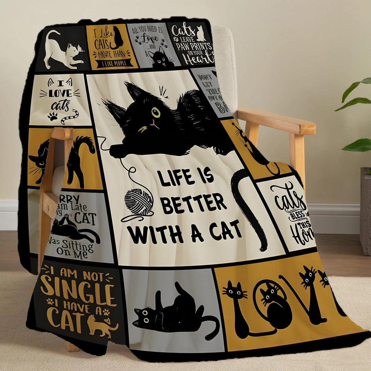 A black and yellow patterned flannel throw blanket featuring cat-themed sayings and illustrations.
