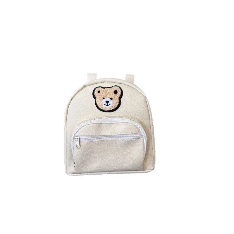 A light beige embroidered bear stroller organizer bag with a zippered pocket.