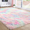 A fluffy rainbow plush area rug featuring soft pink, blue, and white colors on a light wood floor.