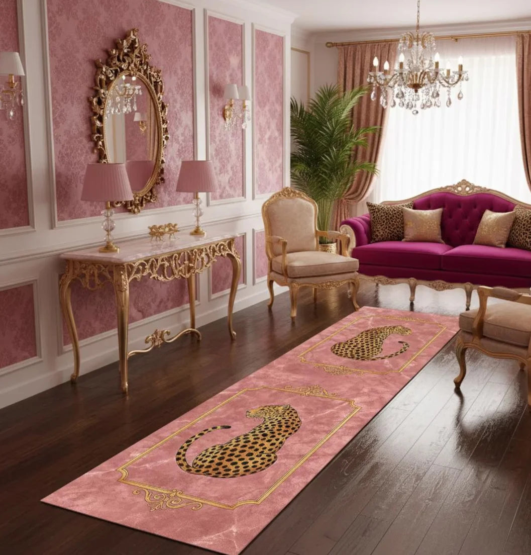 A long pink runner rug with a gold leopard print design on a dark wood floor in an elegant room.