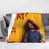 A yellow flannel throw blanket featuring a graphic of Chucky with blood dripping from his mouth.