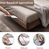 A hand is using a flat tool to fold or organize a bed sheet on a bed.