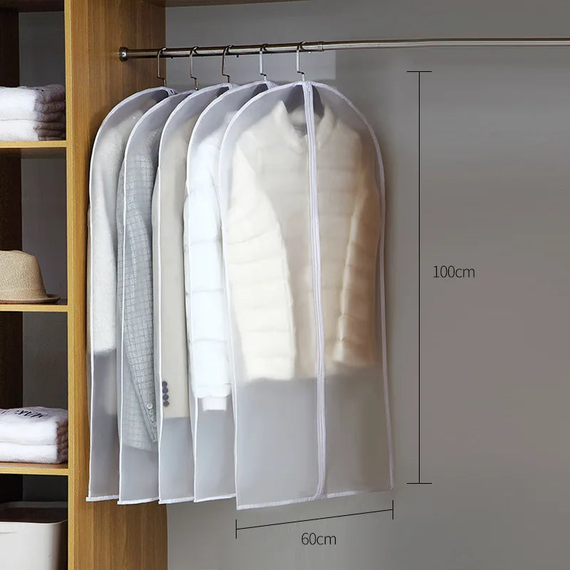 A transparent zippered storage bag hangs on a rod, displaying several white and light-colored garments.
