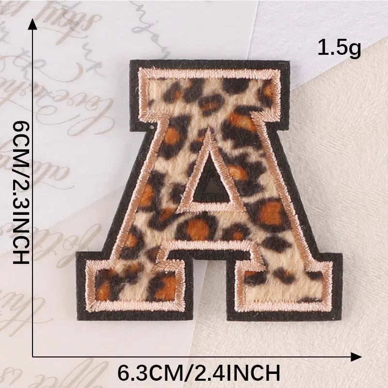 A iron-on patch of the letter A in leopard print fabric