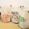 Three natural fabric storage baskets with cartoon designs for baby and dirty clothes