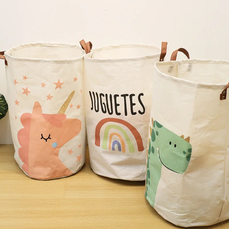 Three natural fabric storage baskets with cartoon designs for baby and dirty clothes