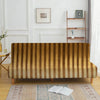 A brown striped velvet sofa cover displayed in a bright room with white wainscoting and wooden shelving.