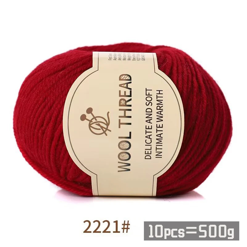 Red wool thread skein with a label indicating delicate and soft intimate warmth