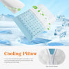 A light blue cooling pillow with a white cover is shown in a snowy outdoor setting.