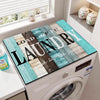 A laundry room scene showing a white washing machine with a wood grain fridge cover mat placed on top.