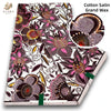 Cotton Satin Grand Wax fabric featuring floral and botanical patterns in pink, purple, and brown tones.