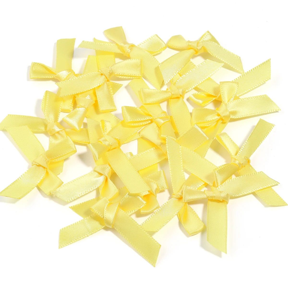 A pile of yellow satin ribbon bows for craft and decoration.