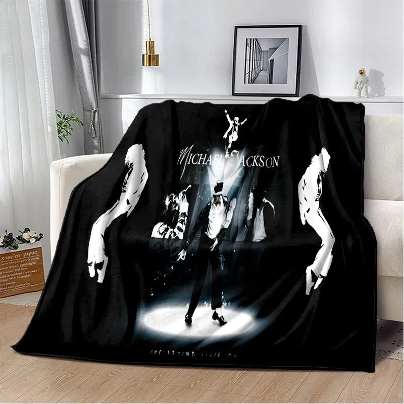 A black flannel throw blanket featuring a white graphic of Michael Jackson performing.