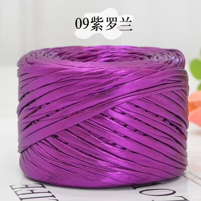 Purple metallic cake yarn wound into a thick coil for crafting