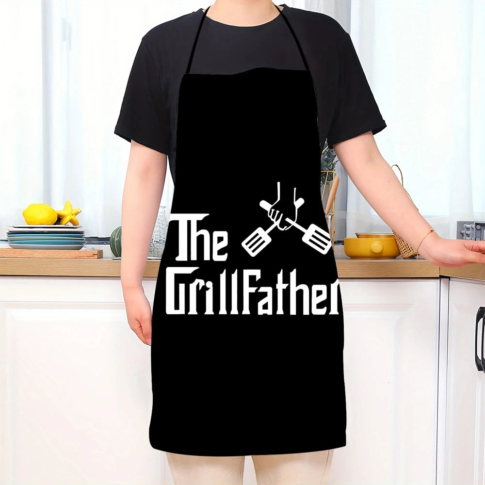 A person wearing a black kitchen chef apron with the text The GrillFather and crossed grilling tools printed on it.