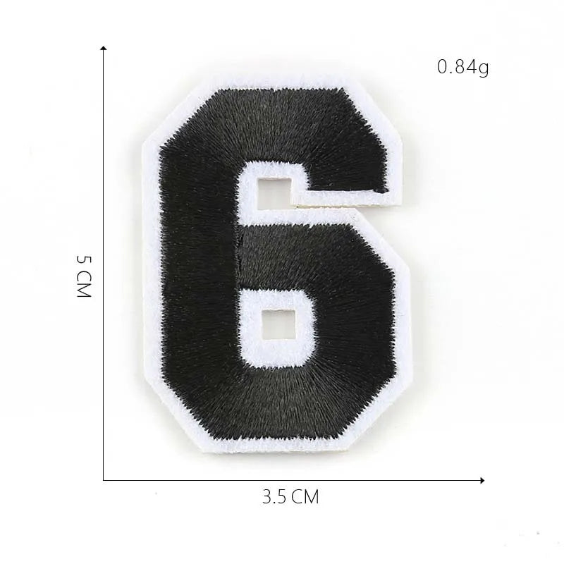 A black felt number six patch with white trim, measuring 3.5 cm by 5 cm and weighing 0.84g.