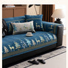 A dark blue sofa mat cover featuring a Christmas deer pattern and gold accents in a living room setting.