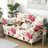 A floral patterned stretch sofa cover featuring pink roses and green leaves in a light cream color.