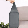 A gray velvet sofa armrest cover is being held by a hand, shown next to a light-colored sofa.