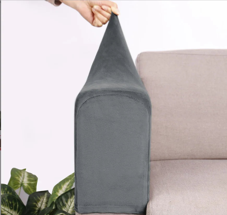 A gray velvet sofa armrest cover is being held by a hand, shown next to a light-colored sofa.
