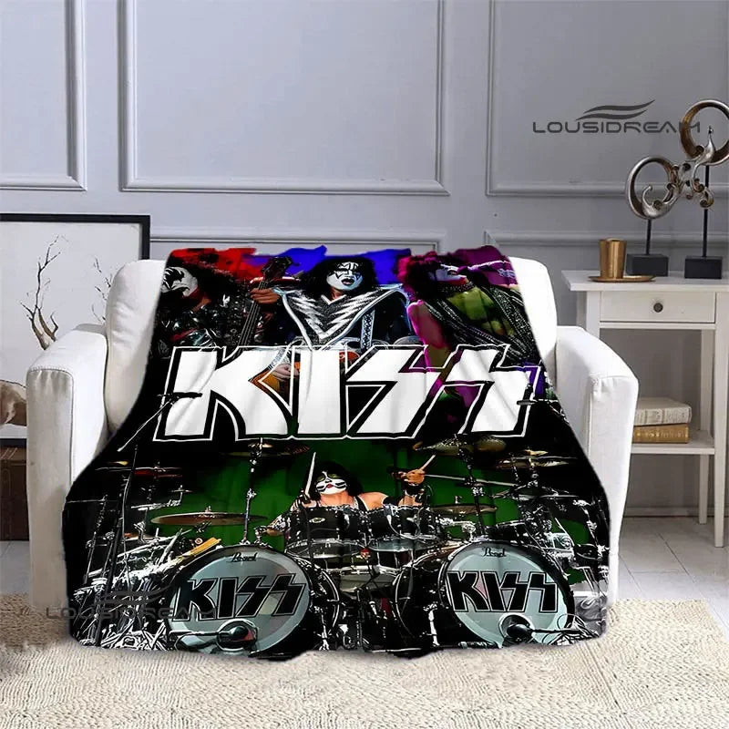 A black and white printed flannel travel blanket featuring the KISS band logo and imagery.