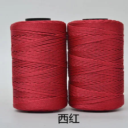 Two spools of red hand knitting and crochet cord for crafting